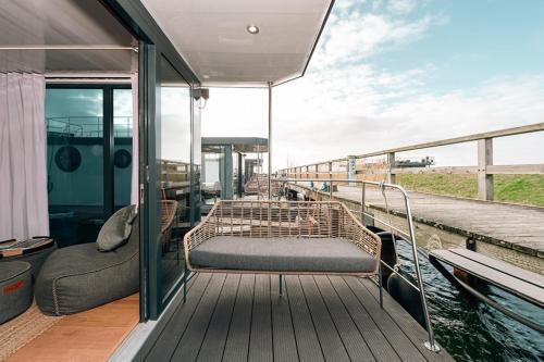 a deck of a boat with a bed and a couch at Sea Lodge in Vieregge