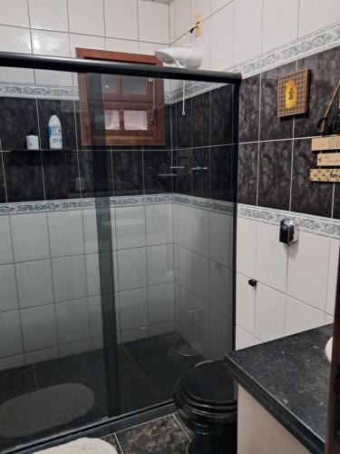 a bathroom with a shower with a toilet in it at Canto dos pássaros in Volta Redonda