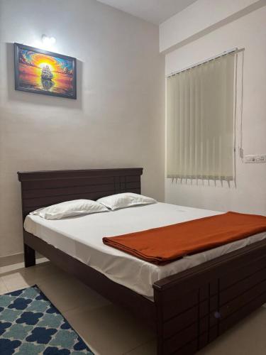 a bedroom with a bed with a wooden frame at Odranest Serviced Apartment in Secunderabad