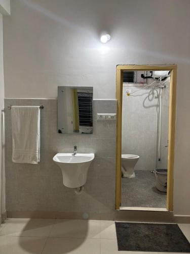a bathroom with a sink and a toilet at Odranest Serviced Apartment in Secunderabad