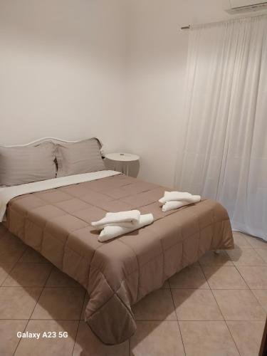 a bedroom with a bed with towels on it at Menidi Apartment 101 in Menídion