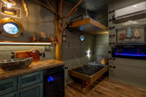a bathroom with a sink and a fish tank at "Squirrels Gone Wild" Luxury Treehouse Adventure Near Dollywood & Pigeon Forge in Sevierville
