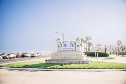 a sign in the middle of a road with cars at Blue Pearl Beachfront Condo at Casa de Mar in Galveston