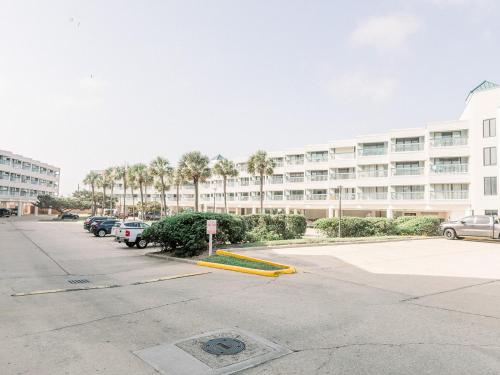 a parking lot in front of a large building at Blue Pearl Beachfront Condo at Casa de Mar in Galveston