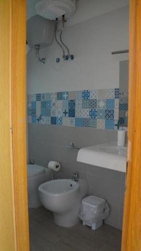 a bathroom with a toilet and a tub and a sink at BlancheMarie in Agropoli