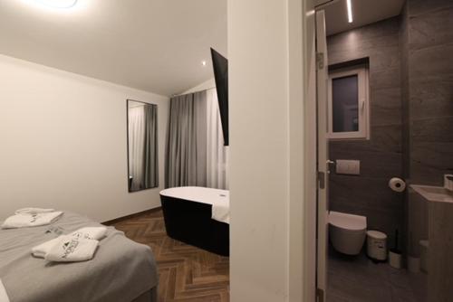 a hotel room with two beds and a bathroom at Montéa Villa in Brezovica