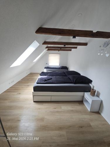 a bedroom with a large bed in a attic at Schneiders Apartment Style House in Trunkelsberg