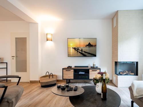 a living room with a couch and a tv at Ferienhaus Amica in Heringsdorf