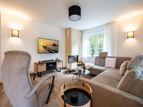 a living room with a couch and a tv at Ferienhaus Amica in Heringsdorf