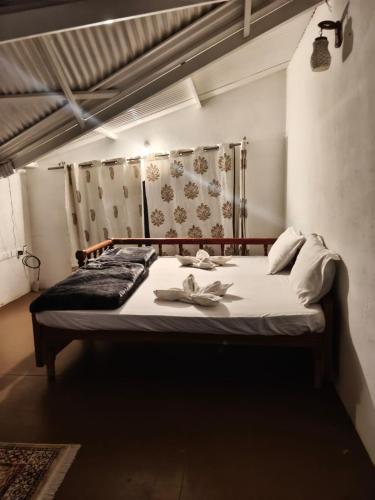 a bedroom with a large bed in a room at The Attic at Infinity Valley in Kotagiri