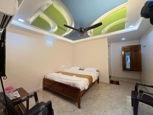 a bedroom with a bed with a ceiling fan at A One Residency in Nāgercoil