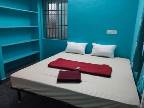 a bedroom with a bed with a red towel on it at D S Villa with swimming pool in Kuilapayam