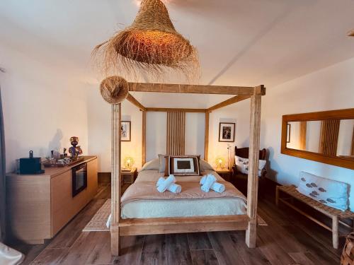 a bedroom with a bed with two teddy bears on it at Maison "LA ROSALINDA-2B" Ghisonaccia in Ghisonaccia