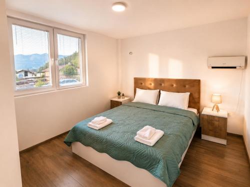 a bedroom with a bed with two towels on it at Bate Bole Mountain Villa in Elshani