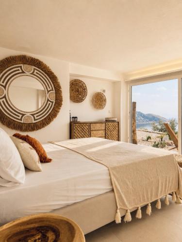 a bedroom with a large bed with a large mirror at Villa Issima Samos, Breathtaking Sea View & Jacuzzi in Samos