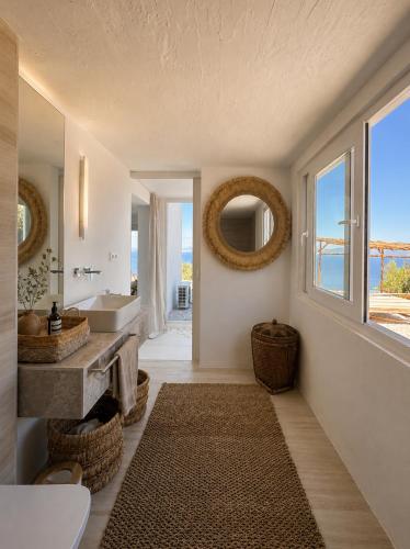a bathroom with a view of the ocean at Villa Issima Samos, Breathtaking Sea View & Jacuzzi in Samos