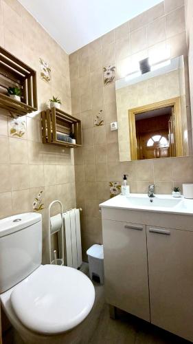 a bathroom with a toilet and a sink at El Racó de la Vero in Falset