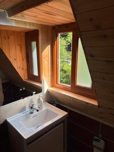 a bathroom with a sink and a window at Guesthouse Bec Villi in Theth