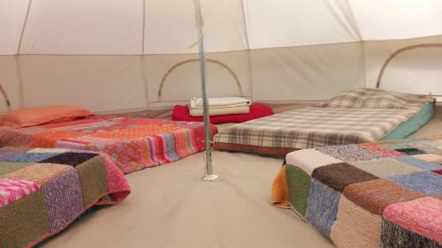 a room with two beds in a tent at La mesange in Vaylats