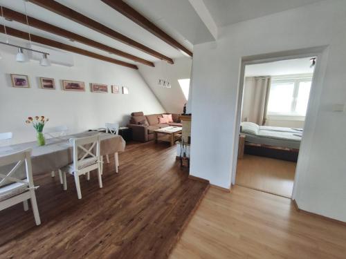 a living room with a dining table and a living room at U Cáfi Valtice in Břeclav