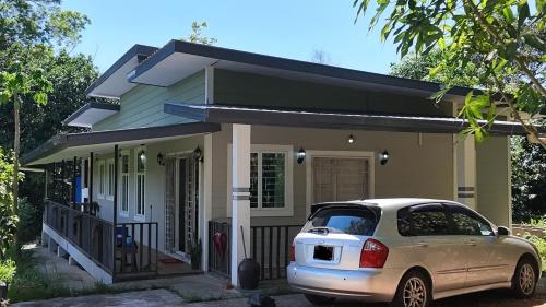a small house with a car parked in front of it at Homestay House - Tamparuli in Tamparuli