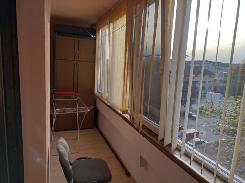 a room with a chair and a window with a view at CaSa BOULEVARD in Brčko