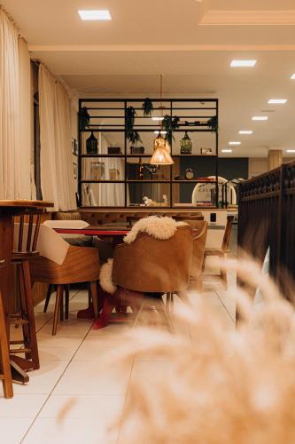 a dining room with a table and chairs at Hotel Daieli in Otacílio Costa