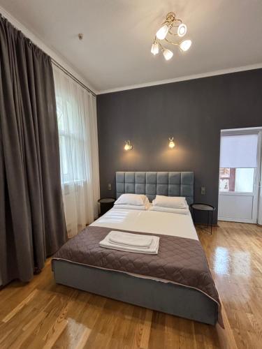 a bedroom with a bed and a ceiling fan at Villa Viktoriya Hotel in Truskavets