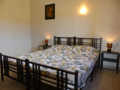 a bedroom with a bed with a floral comforter at Casa Nuestra Roca in Vélez-Rubio