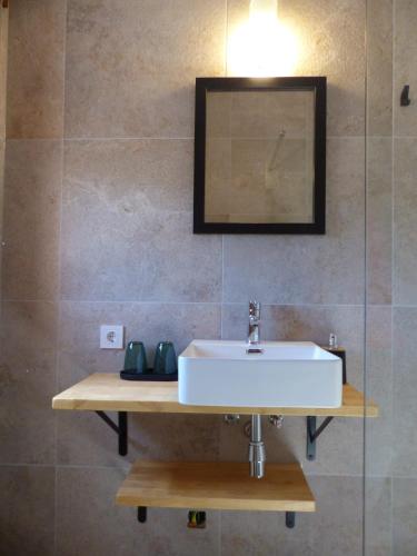 a bathroom with a sink and a mirror at Casa Nuestra Roca in Vélez-Rubio