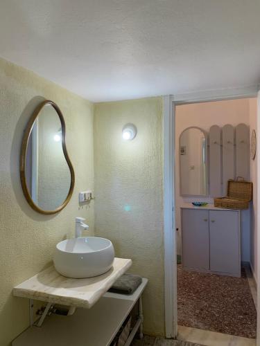 a bathroom with a sink and a mirror at Kalelia in Nea Potidaea