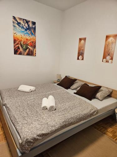 a bedroom with a bed with two slippers on it at Kuća za odmor Širok šor in Vukovar