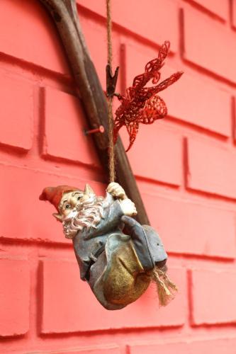 a bird ornament hanging from a red wall at Posada del Parque in Concón