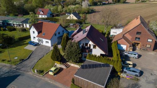 an overhead view of a house with cars parked in a driveway at FeWo im Lippischen Bergland in Kalletal