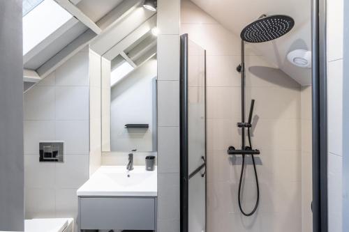 a bathroom with a shower and a sink at La Retraite in Wolferton