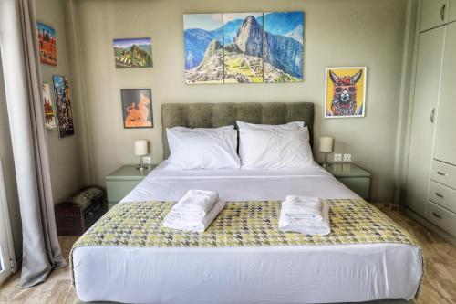 a bedroom with a bed with two towels on it at Stella Di Mare Pylos in Pylos