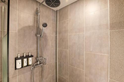 a bathroom with a shower with a shower head at Hotel K-Tree Pyeongtaek in Pyeongtaek