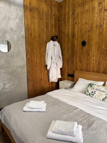a bedroom with a bed with towels on it at Sky hugs cottage in Volosyanka