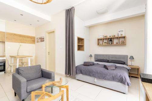 a bedroom with a bed and a chair at Lavender Bay E2-1-studio apartment in Donji Morinj