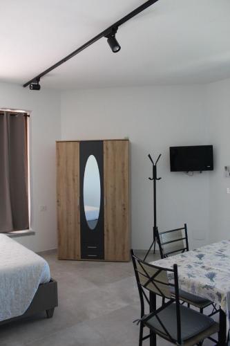 a bedroom with a bed and a tv on a wall at I Tre Ulivi 1 in Mozzate