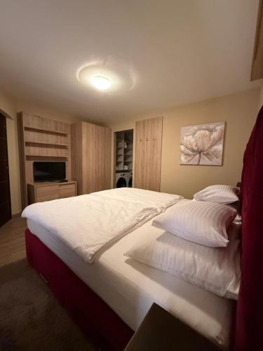 a bedroom with a large bed with white sheets at Tkalča Room 22 in Zagreb