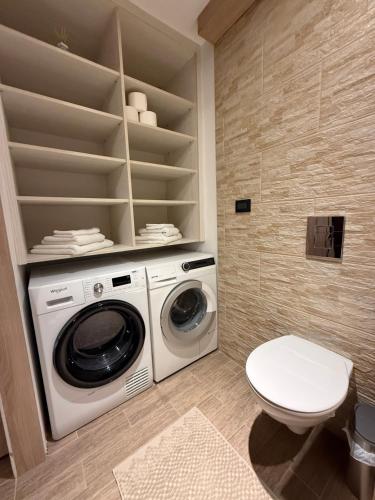 a laundry room with a washing machine and a toilet at Tkalča Room 22 in Zagreb