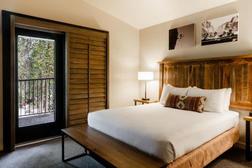a bedroom with a large bed and a window at Waybound Yosemite in Fish Camp