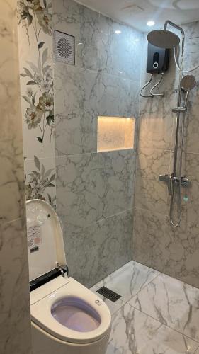 a bathroom with a toilet and a shower at Travellers Staycation in San Jose del Monte