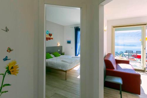 a bedroom with a bed and a living room at La Collina dei Fiori in Vercana