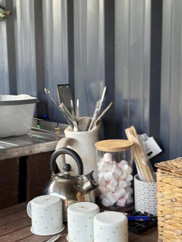 a kitchen counter with a tea kettle and utensils at Four Seasons Mini Zoo Country Retreat with Wood Fuel Hot Tub close to kington Market Town in Hereford