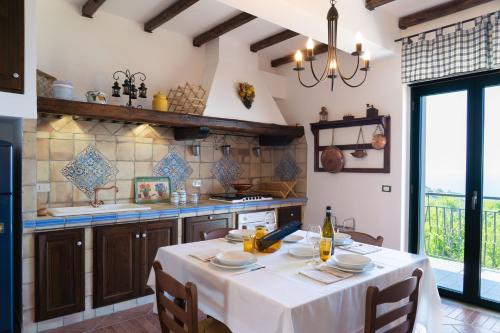 a kitchen with a table with a white table cloth at Cresta Panoramic apartments in Naso