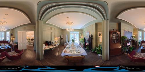 a living room with a table in the middle of it at Avoca House in Dublin