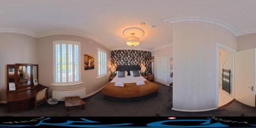 a bedroom with a bed in the middle of a room at Avoca House in Dublin