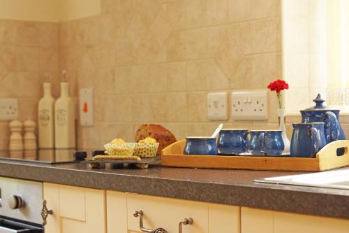 a kitchen with a counter with blue dishes on it at Hen Gapel in Aberhosan